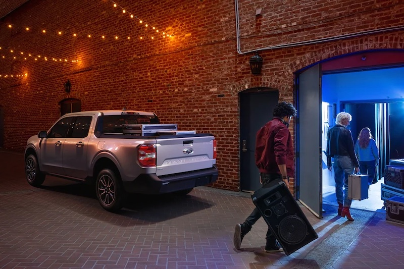 Ford Maverick Parked In Alley With People Carrying Band Equipment Into Club